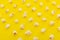 High angle view of popcorn in multiple rows on yellow background