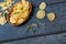 High angle view of potato chips in bowl with rosemary and salt on wooden table