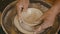 High-Angle View Of Potter's Hands Shaping A Clay Pot Indoors