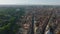 High angle view of road in city surrounded by remains of ancient sites. Tilt up reveal of cityscape with Colosseum