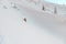 high angle view of skier riding down on snow-covered mountain slope. Freeride.