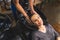 High angle view of smiling relaxed woman having her hair washed and massaged by unrecognizable hairdresser worker