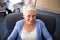 High angle view of smiling senior woman sitting on armchair