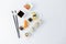 High angle view of sushi rolls and nigiri meal set with chopsticks, soy sauce, wasabi and gari on table