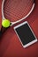 High angle view of tennis ball and racket by digital tablet