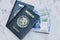 High angle view of two Mexican Passports and pesos on the table under the lights