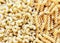 High angle view of uncooked elbow macaroni and spiral pasta