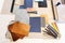 High angle view of various patterned fabric swatches and work tools on table in office