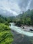 High-angle view of water flowing over Babinda Boulders surrounded by mesmerizing trees in Queensland