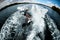 High angle view of woman riding on the wake surf holding rope of motorboat