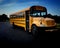 High angle view of yellow American public school bus front right door side commonly used to transport kids to school, field trips