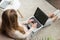 high angle view of young female developer coding with laptop