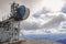 high antennas on the top of a mountain in austria with white clouds