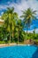 High, beautiful palm trees rostut poolside, around a luxury hotel. tropics asia