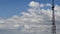 High blue sky and floating white clouds with communication tower