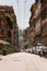 High buildings and parked cars and motorbikes. Street Via Balbi in Genoa, Italy.