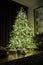 High Christmas tree with ornaments and garlands