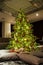 High Christmas tree with ornaments and garlands