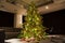 High Christmas tree with ornaments and garlands