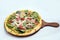 `A high contrast Hero shot of a Bruschetta Al Pesto Spinaci Pizza, on a minimal white background with a 60 degree angle from zoome