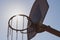 High contrast image of basketball hoop backlit with sun flare