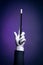 High contrast image of magician hand with magic wand