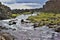 High contrast scenery made of mountain creek between dark hills in Thingvellir National Park