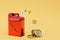 high cost of engine fuel. red canister with fuel and dollars on a yellow background. 3d render