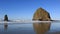 High definition 1080p zooming out movie of beautiful Cannon Beach with its well-known Haystack Rock landmark and Needles located n
