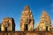 High-definition photograph showcasing the three tall brick towers of the Pre Rup temple complex under a clear blue sky, a classic