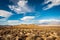 High desert landscape to distant hills with OHV dirt track