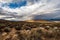 High desert landscape to distant hills with OHV dirt track