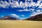 High dynamic range image of barren mountain in a desert with deep blue sky and white patchy clouds in ladakh, Jammu and Kashmir,