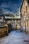 High dynamic range photograph of a street in the old part of Vitoria, Spain, with part of a crenellated wall and its