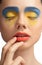 High fashion look, closeup beauty portrait,bright makeup with perfect clean skin with colorful red lips and blue yellow