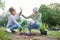 High five, child and woman with plant for gardening, ecology and agriculture in a park with trees. Volunteer family