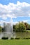 High fountain in the pond in a park on a sunny day