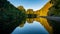 High hedge and its reflection in the pond, Oliwa Park.