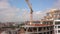 High industrial tower crane at construction site of new residential building.