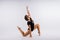 High jump, flight. Little flexible girl, rhythmic gymnastics artist jumping. Grace motion, action.