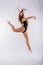 High jump, flight. Little flexible girl, rhythmic gymnastics artist jumping. Grace motion, action.