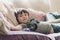 High key light happy boy lying on fluffy pillow on sofa, Selective focus Adorable child with smiling face relaxing at home on