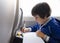 High key portarit Kid traveling by the train, Child drawing cartoon on white paper sitting by the window. Little boy in a high