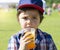 High key Portrait of kid boy drinking orange slush from plastic glass in hot sunny day,Thirsty child drinking frozen orange slush