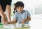 High key portrait kid playing game in playroom with parent, father and Child holding bottom game with wondering face in a sunny