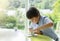 High key portrait of school kid playing game in playroomwith blurry natural background, Child holding bottom game with wondering