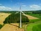 High level aspect aerial view of a wind turbine in a small rural wind farm
