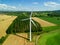 High level aspect aerial view of a wind turbine in a small rural wind farm