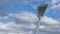 High mast on a background of a cloudy sky. Light pole under the blue sky. Space for text. Light pole tower with blue sky