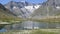 High mountain alpine snow covered peaks and a crystal clean alpine stream